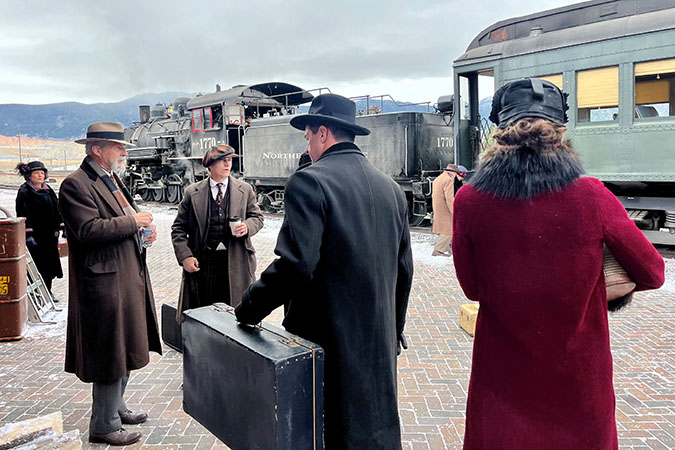 Cast and crew mingle during filming. Far right: Brian Konowal, who plays Clyde, with his body double, Tad Griffith, behind him.