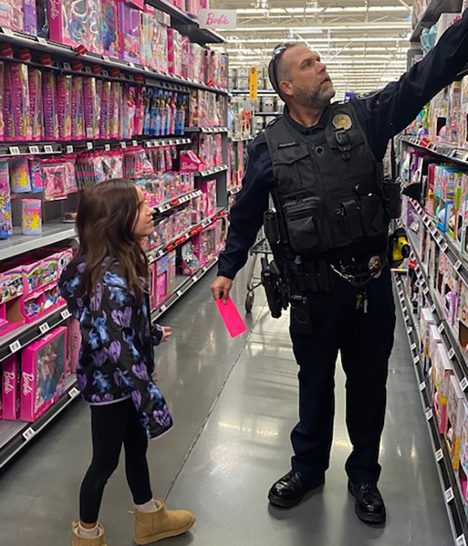 Rick Colbert helps a young shopper. 